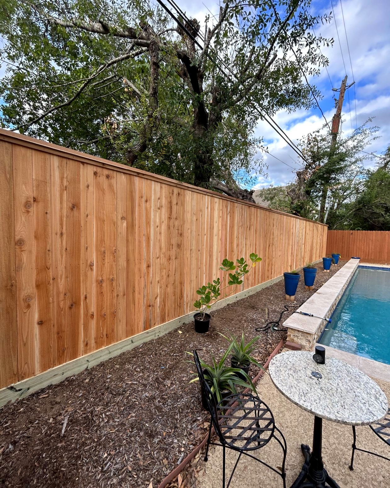 Cedar privacy fence built by L&K Wood Fence Services along a Houston pool yard
