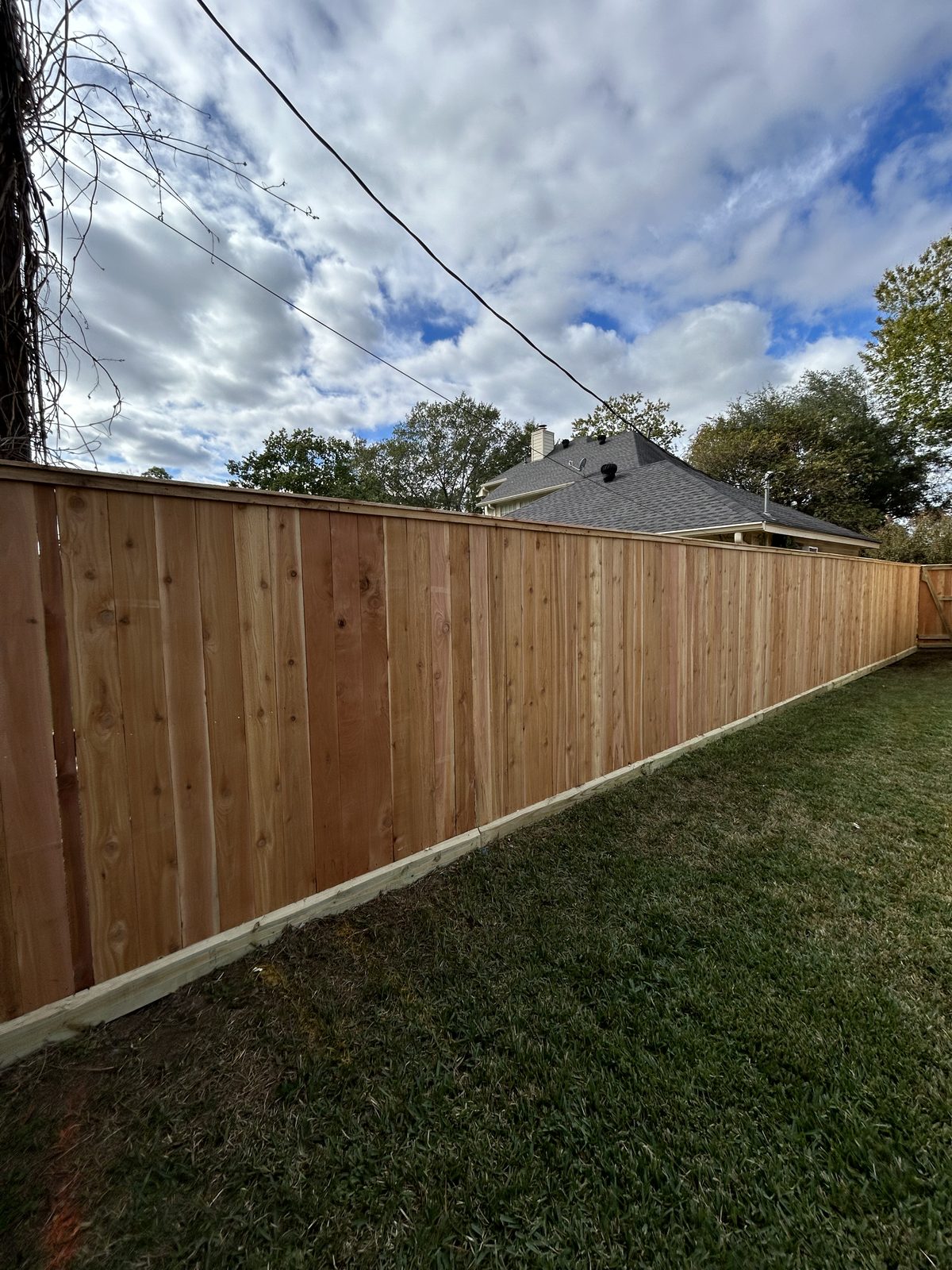Finished cedar privacy fence along a Houston property line
